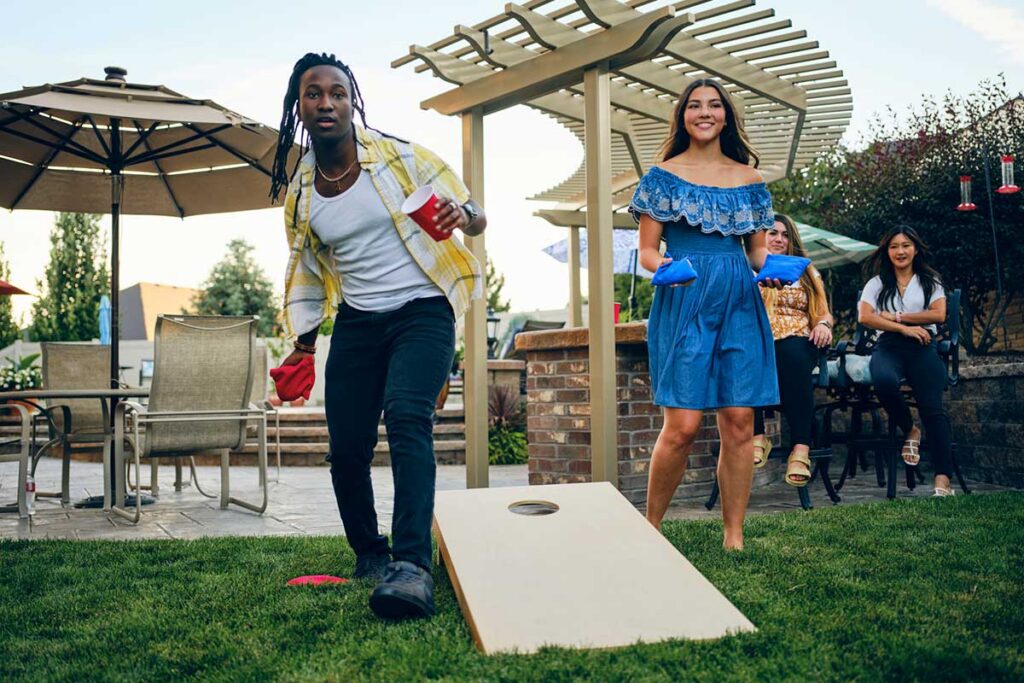 People playing cornhole outdoors